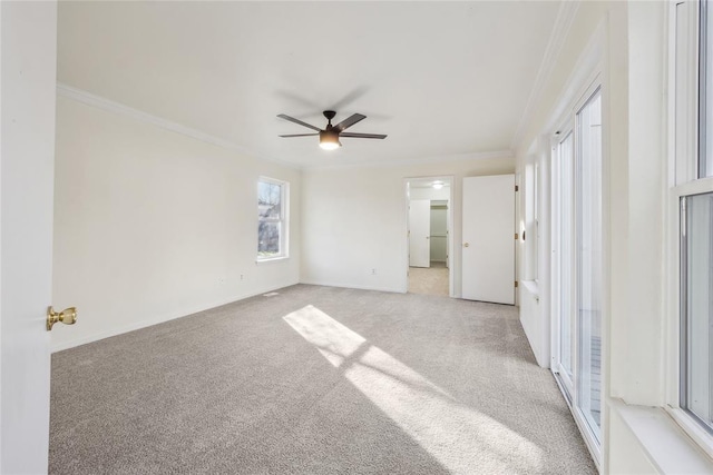 unfurnished room with ceiling fan, baseboards, light carpet, and ornamental molding