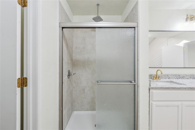 full bath featuring vanity and a shower stall