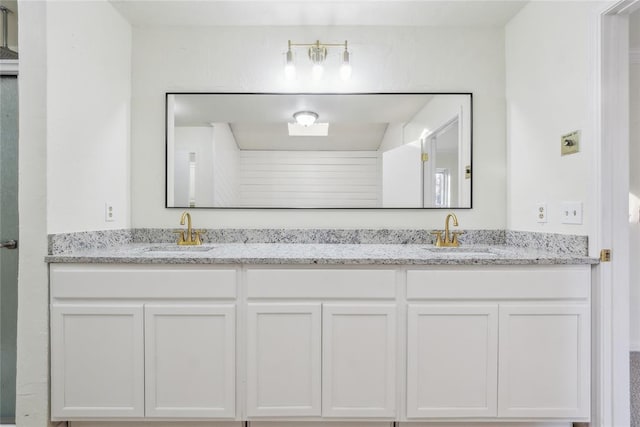 full bath with double vanity and a sink