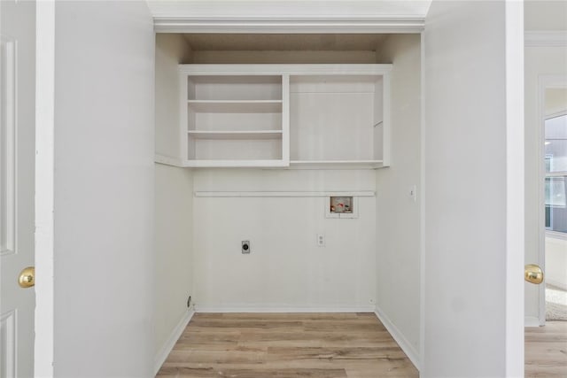 washroom featuring hookup for a washing machine, light wood finished floors, hookup for an electric dryer, and laundry area