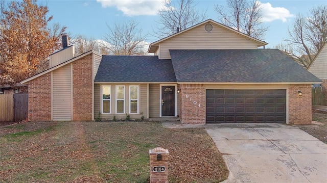 traditional-style home with brick siding, an attached garage, and concrete driveway