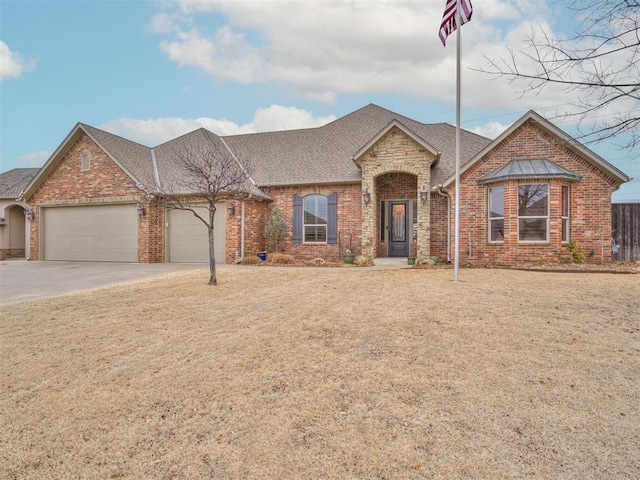 view of front of property featuring brick siding, an attached garage, and roof with shingles