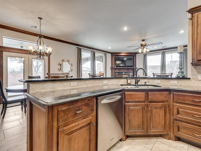 kitchen featuring visible vents, brown cabinetry, dishwasher, a sink, and backsplash