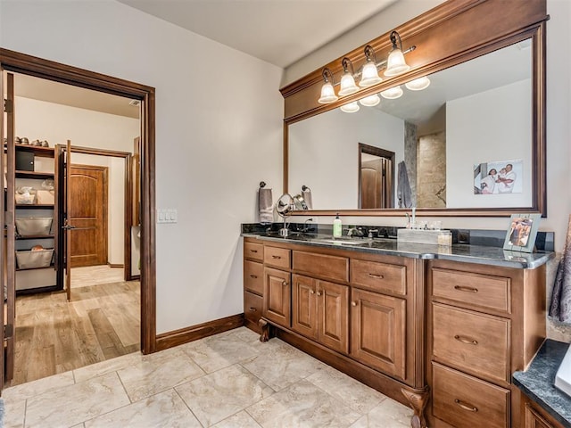 bathroom featuring baseboards and vanity