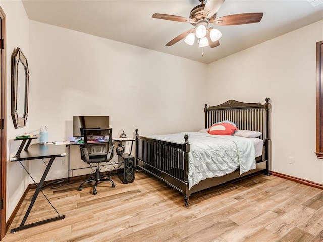 bedroom featuring ceiling fan, baseboards, and wood finished floors