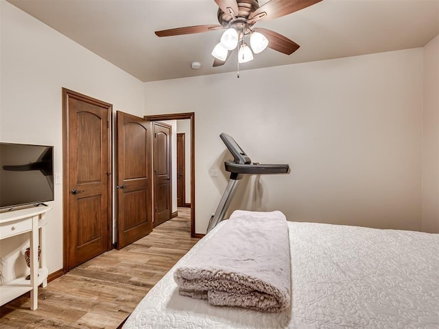 bedroom with light wood-type flooring, baseboards, and a ceiling fan