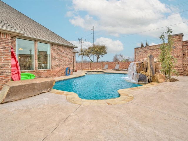 view of swimming pool with a patio area, a jacuzzi, and a fenced in pool