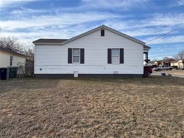 exterior space with a lawn and fence