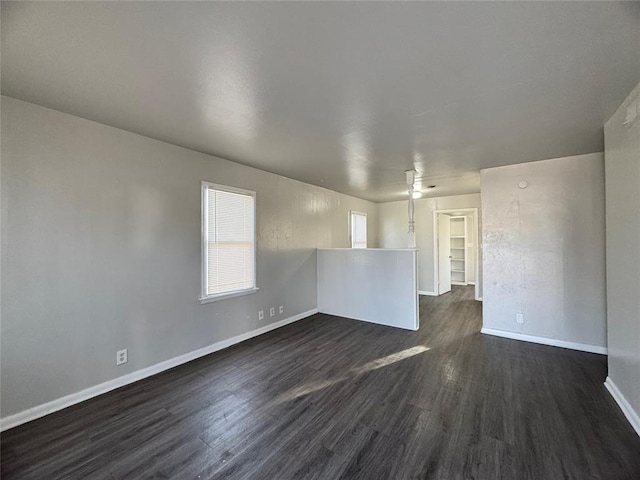 unfurnished room featuring dark wood finished floors and baseboards