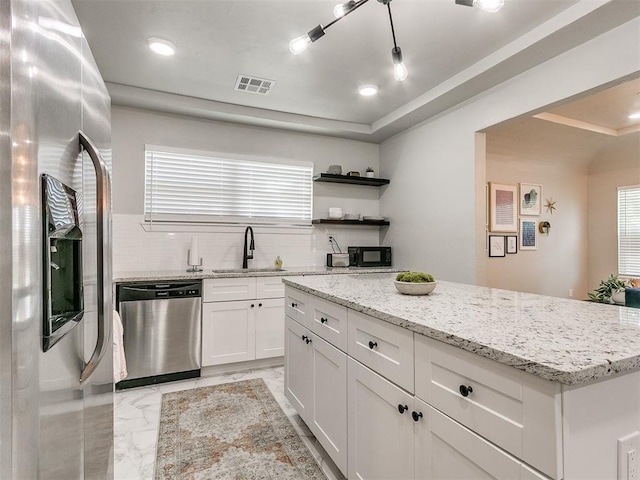 kitchen featuring marble finish floor, visible vents, appliances with stainless steel finishes, white cabinetry, and a sink