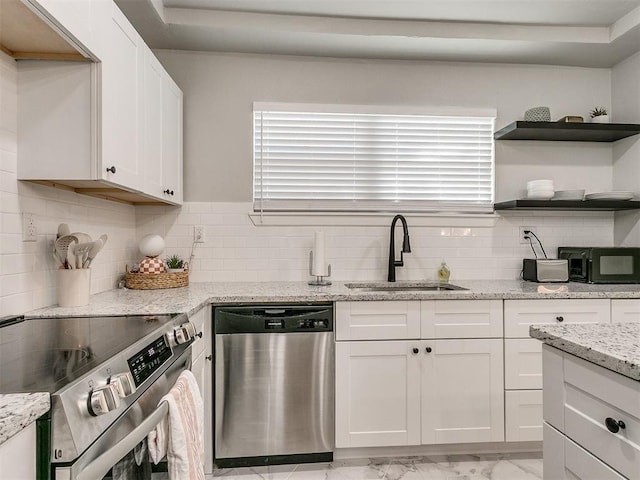 kitchen with decorative backsplash, marble finish floor, stainless steel appliances, white cabinetry, and a sink