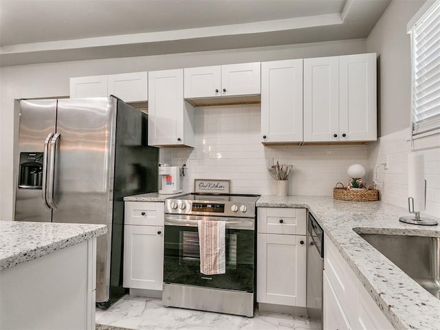 kitchen featuring marble finish floor, stainless steel appliances, and white cabinetry