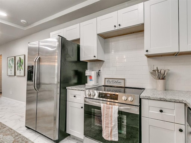 kitchen featuring appliances with stainless steel finishes, marble finish floor, white cabinets, and backsplash