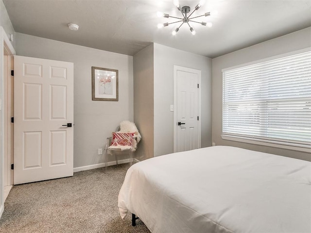 bedroom with light carpet, an inviting chandelier, and baseboards