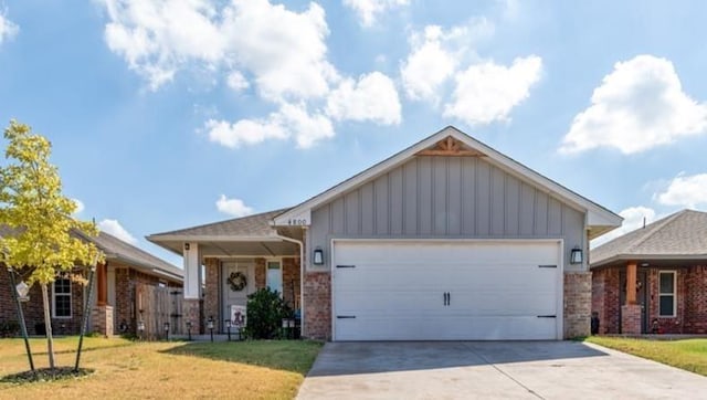 ranch-style house with a garage, driveway, board and batten siding, and a front yard