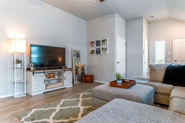 living room with high vaulted ceiling, a ceiling fan, visible vents, and wood finished floors