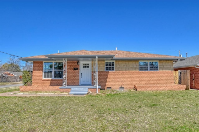 bungalow-style house featuring crawl space, brick siding, a front yard, and roof with shingles