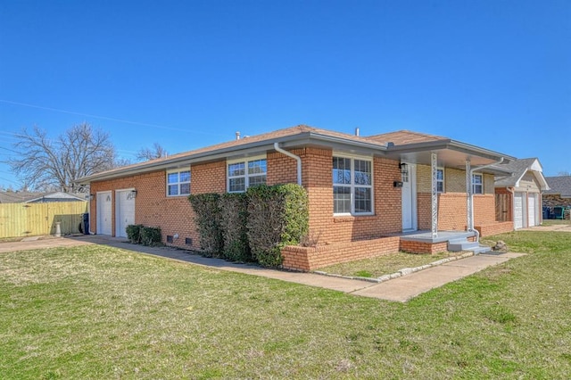 view of front facade featuring brick siding, a front lawn, fence, concrete driveway, and a garage