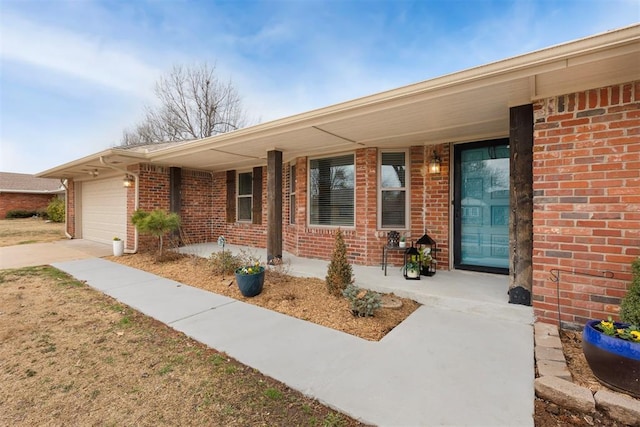 exterior space featuring an attached garage and brick siding