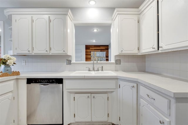 kitchen with a sink, tasteful backsplash, white cabinets, and dishwasher