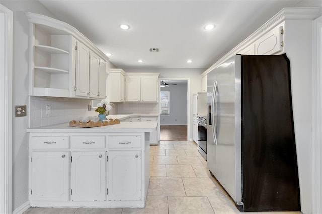 kitchen featuring open shelves, visible vents, appliances with stainless steel finishes, a sink, and a peninsula