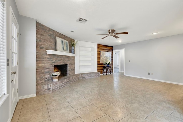 unfurnished living room with baseboards, a fireplace, visible vents, and built in features