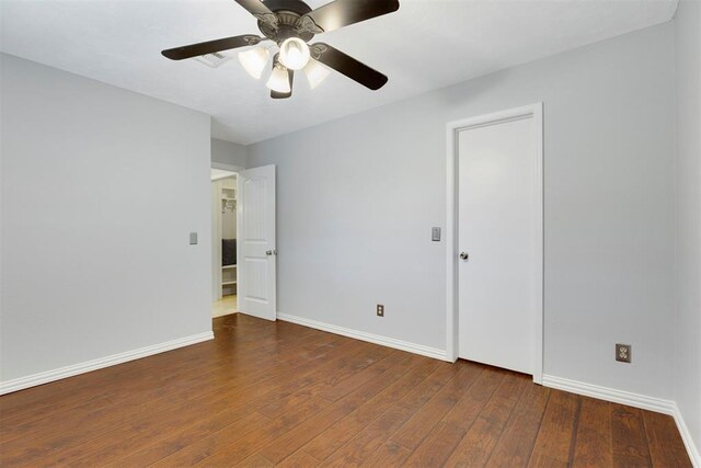 unfurnished bedroom with hardwood / wood-style flooring, visible vents, baseboards, and a ceiling fan