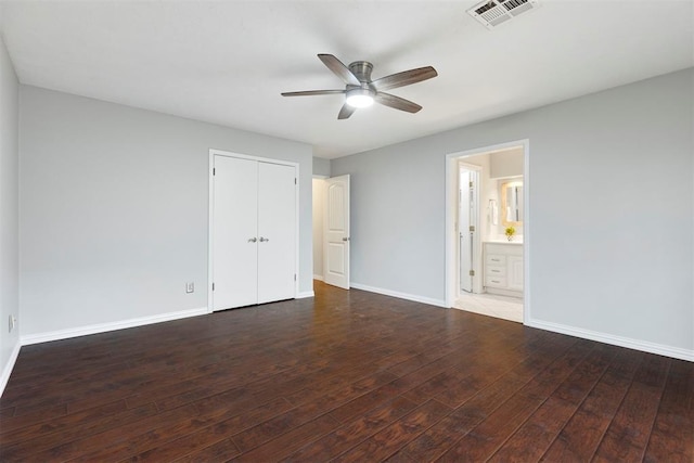 unfurnished bedroom with hardwood / wood-style flooring, baseboards, and visible vents