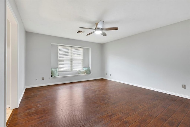 unfurnished room with hardwood / wood-style flooring, ceiling fan, visible vents, and baseboards