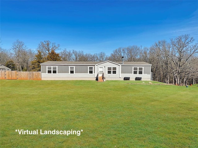 back of property featuring entry steps, a lawn, and fence