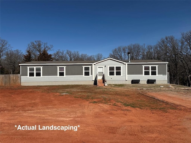 manufactured / mobile home with entry steps and fence