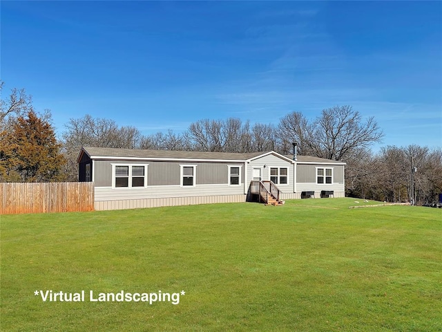 back of property featuring entry steps, a yard, and fence