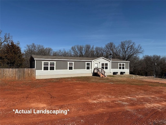 manufactured / mobile home with entry steps and fence