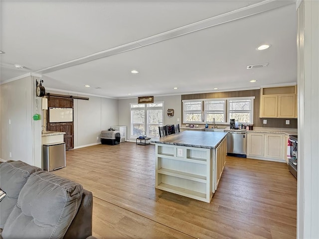 kitchen featuring open shelves, visible vents, a barn door, appliances with stainless steel finishes, and open floor plan