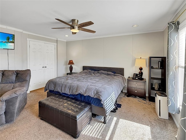 carpeted bedroom with ceiling fan, a decorative wall, recessed lighting, and crown molding