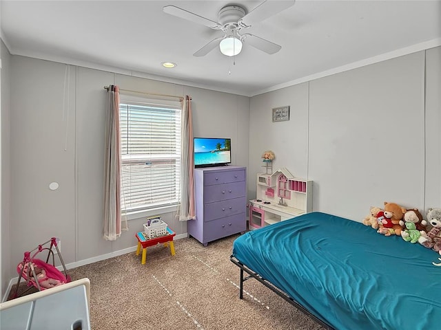 carpeted bedroom with crown molding, a ceiling fan, and baseboards