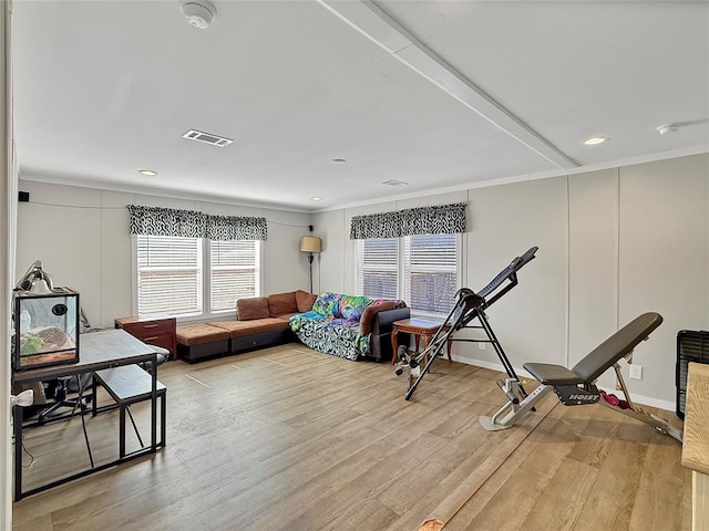 workout room featuring light wood-type flooring and visible vents