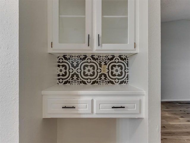 room details with backsplash and wood finished floors