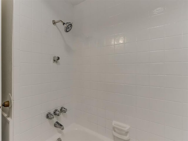 room details featuring shower / bathtub combination