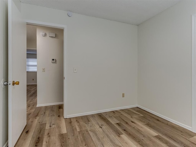 unfurnished room featuring light wood-style floors and baseboards