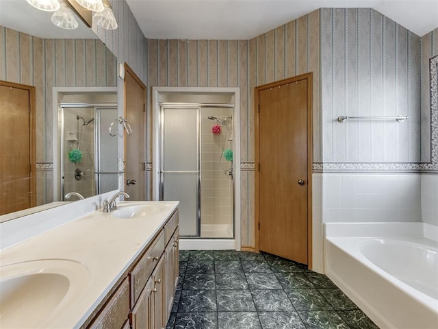 bathroom featuring a garden tub, a sink, a shower stall, and wallpapered walls