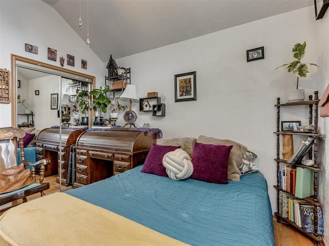 bedroom featuring lofted ceiling and wood finished floors