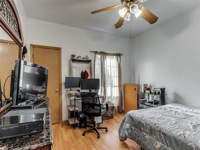 bedroom with light wood-style floors and a ceiling fan