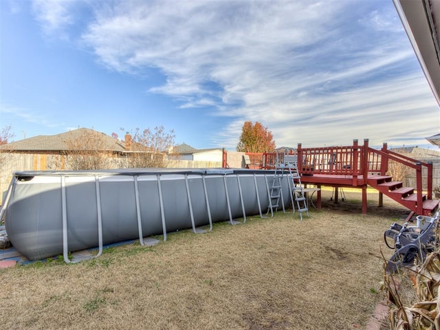 view of yard with a deck and an outdoor pool