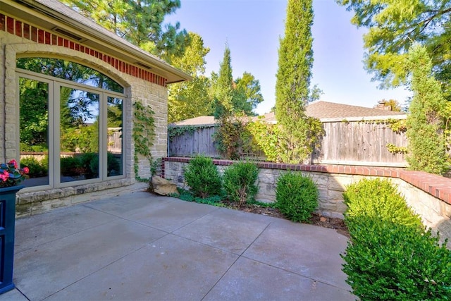 view of patio featuring fence