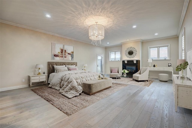 bedroom featuring crown molding, recessed lighting, a glass covered fireplace, wood finished floors, and baseboards