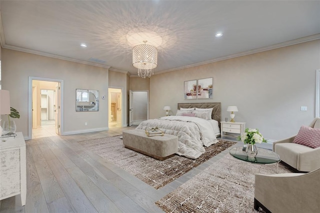 bedroom with ensuite bathroom, a chandelier, baseboards, ornamental molding, and hardwood / wood-style floors