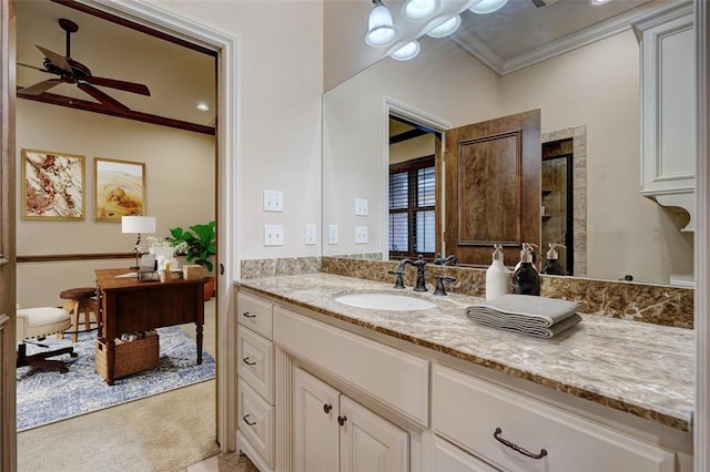 bathroom featuring a ceiling fan, crown molding, and vanity