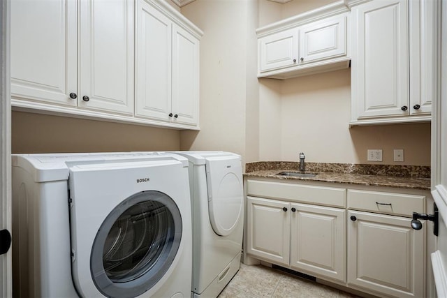 laundry area with cabinet space, a sink, washing machine and clothes dryer, and light tile patterned flooring