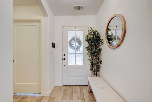 entryway with visible vents, light wood-style flooring, and baseboards